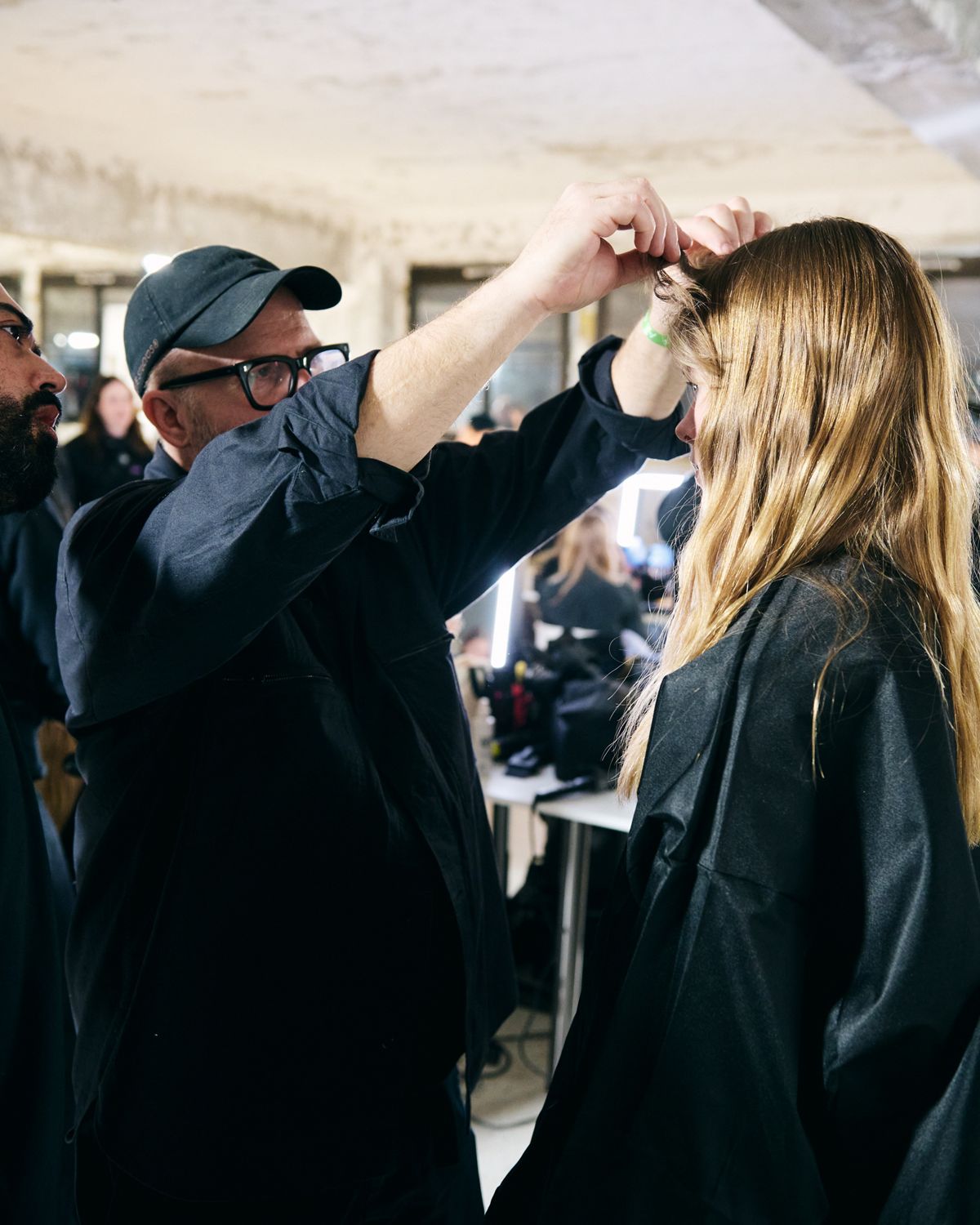 Hairstylist doing hair on a model